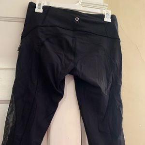 Lululemon black capris with mesh design on bottom side of legs